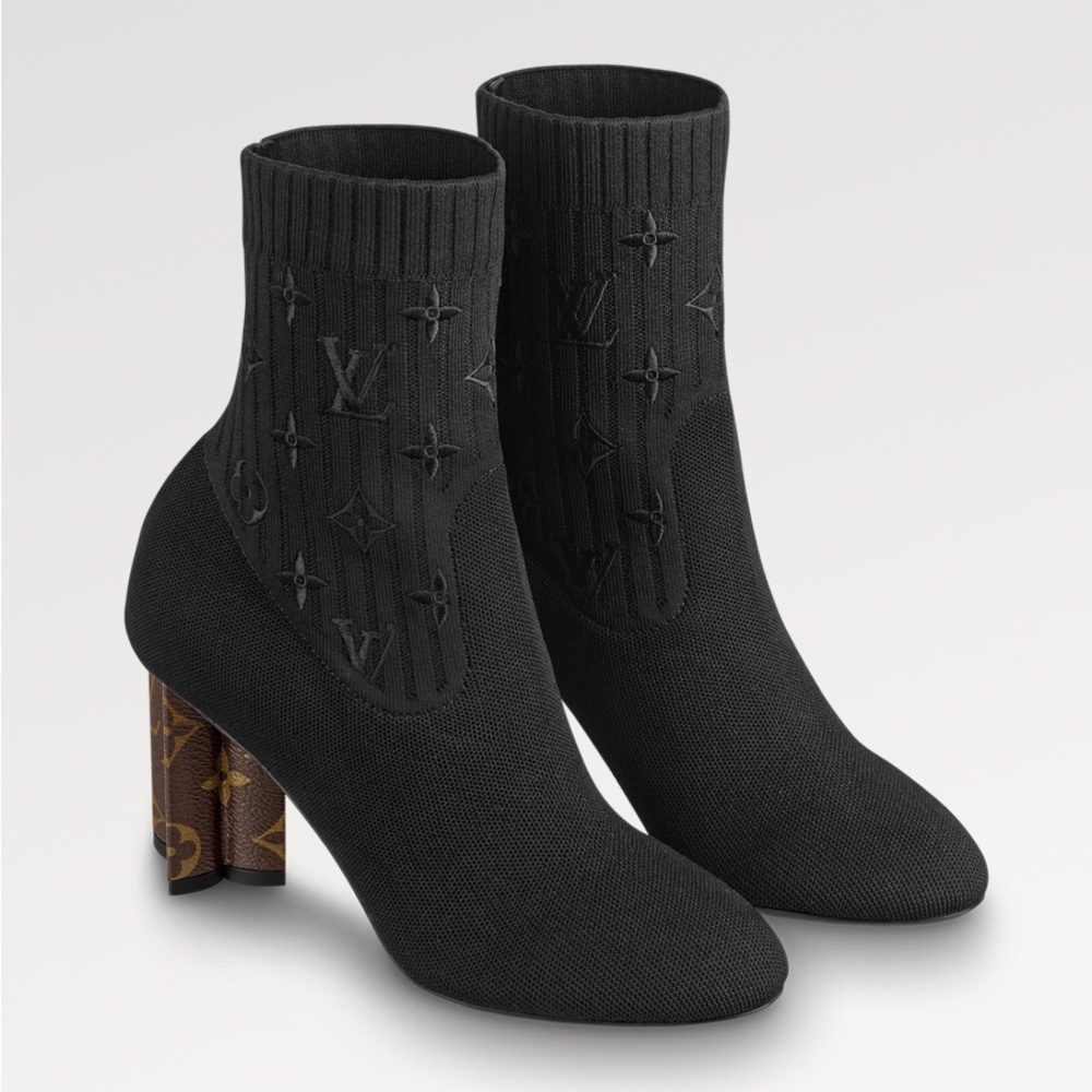 Never worn authentic LV Boot. This boot heel is shaped like a Monogram Flower.